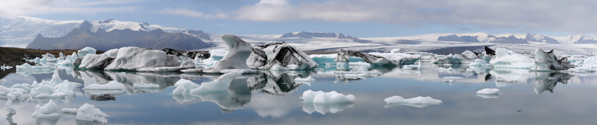 Icebergs, glacier and mountains reflected in Jokulsarlon lagoon, Iceland