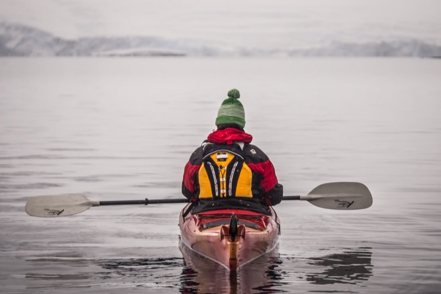 Kayaker exploring calm Antarctic waters